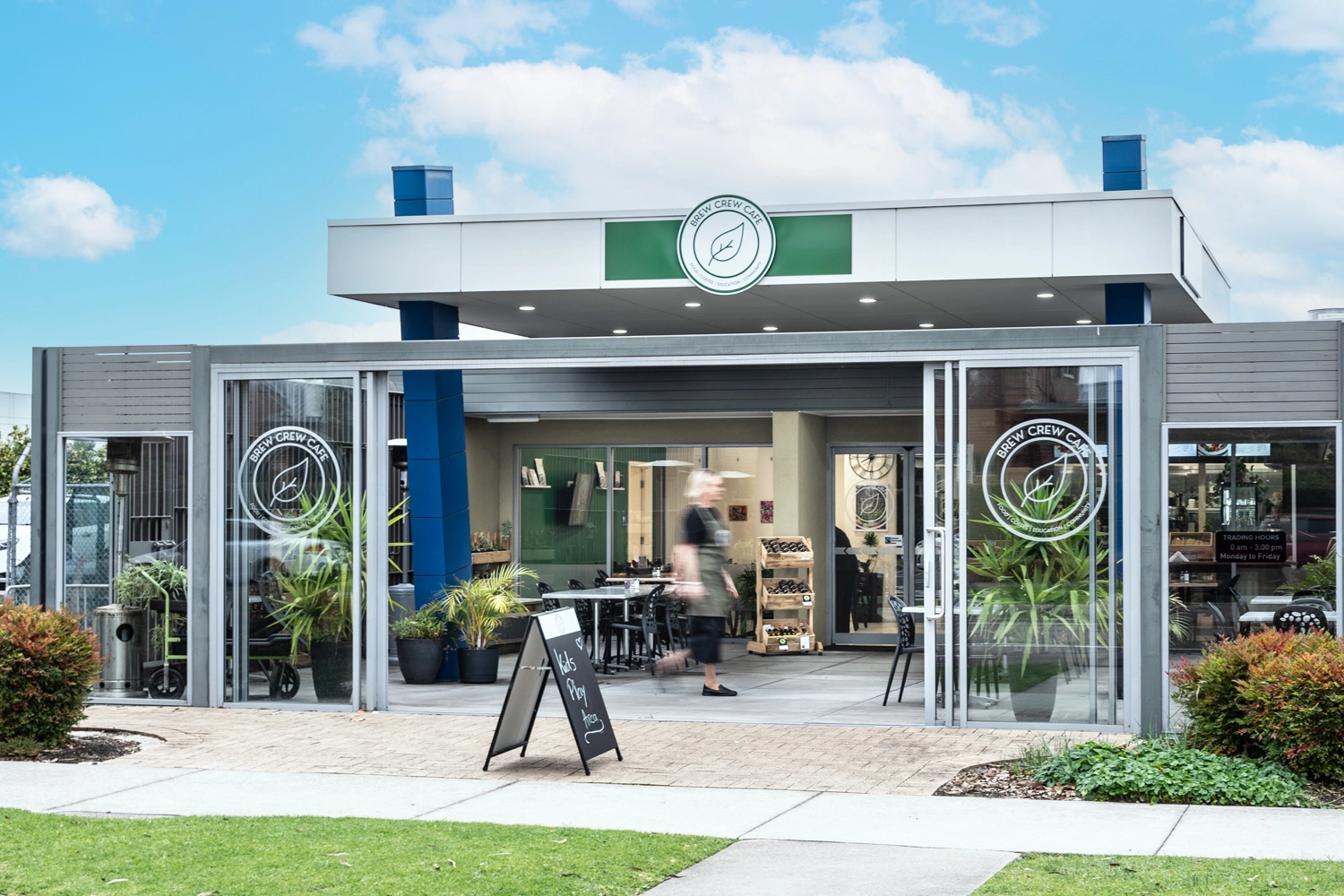 Brew crew cafe cake counter with supported employee behind the counter at NDIS registered disability support Distinctive Options