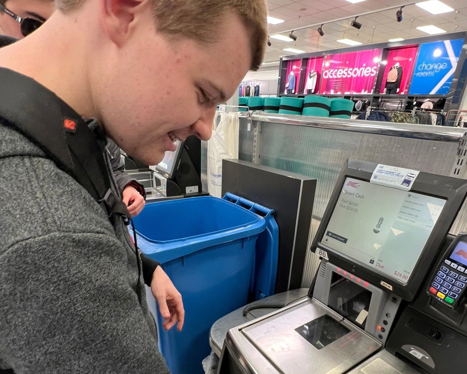 A man uses a self service checkout at a supermarket at Independent Living Supports Distinctive Options disability