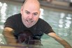 A man swims in a pool at NDIS registered disability service Distinctive Options Independent living supports