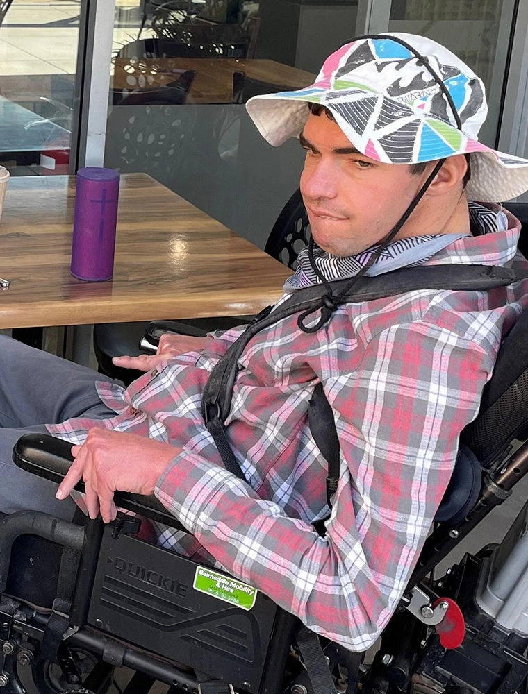 Customer who uses wheelchair at Brew Crew Cafe at NDIS registered disability support Distinctive Options