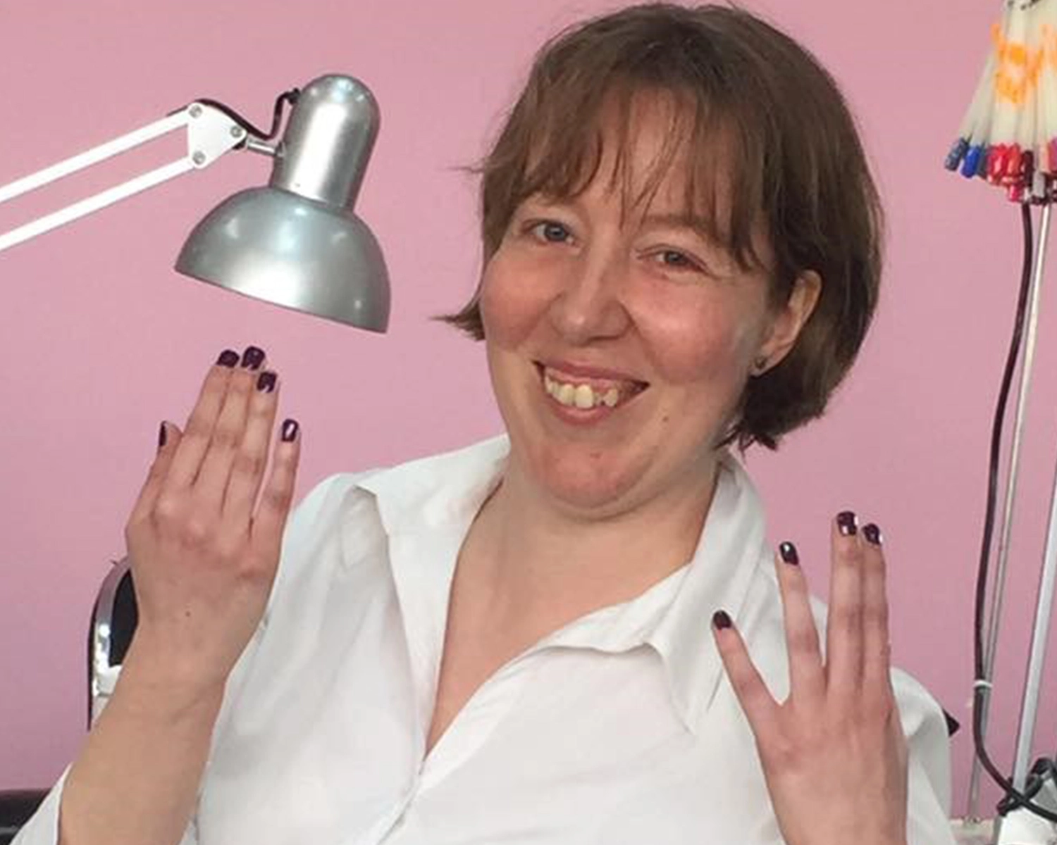 A woman shows her painted nails at NDIS registered disability service Distinctive Options